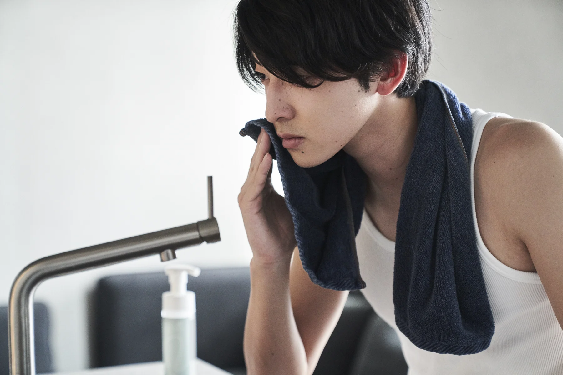 洗顔後にタオルで顔を拭く男性